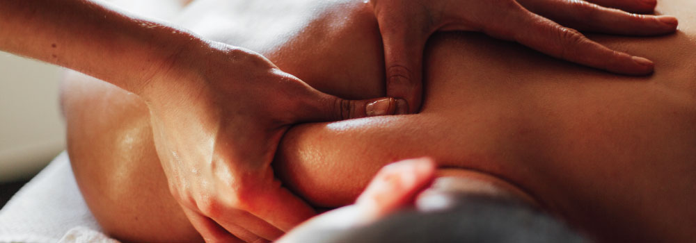 Massage therapist giving a deep tissue massage.